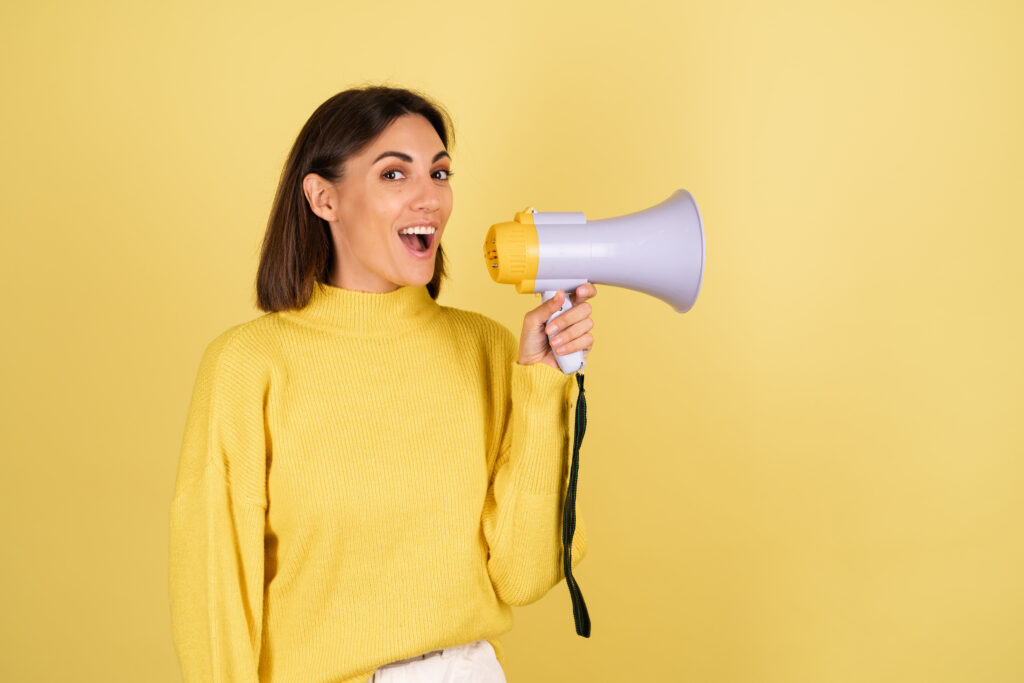 young-woman-yellow-warm-sweater-with-megaphone-speaker-excited-screaming-1024x683 Como Saber se Estou Enlouquecendo? Sinais de Alerta e Quando Procurar Ajuda